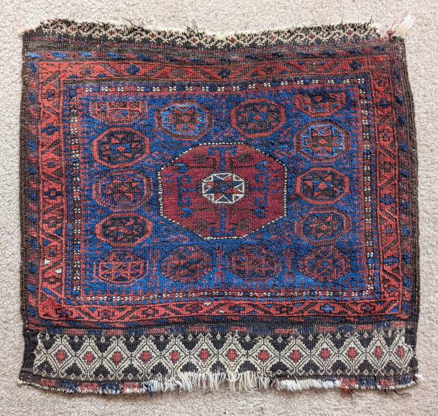 Small Khorosan Baluch octagon star bag face with vivid polychromatic blues and a substantial and dramatic flat-woven band of floating weft work.small size measuring 25"x22". Former James Douglas collection    