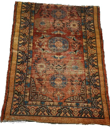 Fragmented East Turkestan Khotan Carpet, great color and classic one medallion drawing. Top border missing. 155 x 236 cm              