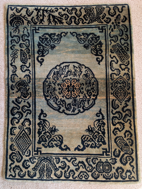Small Tibetan rug with auspicious bats and cloudbands. Likely based in a Chinese textile design. Dramatic abrash, all natural dyes, great condition           