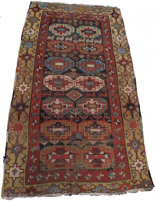Northwest Persian Kurd rug with Memling guls, animals and flowers on a dark ground. Camel ground border with good color including several greens and aubergine.  3'9"x6'10"      