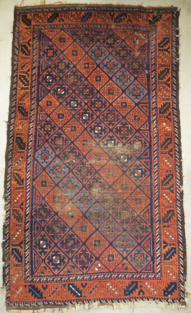 Baluch rug with serrated ashik-like tile design and a leaf border. Several blues, nice color in general. Goat hair side selvedge. 3'6"x6'3"
 
          