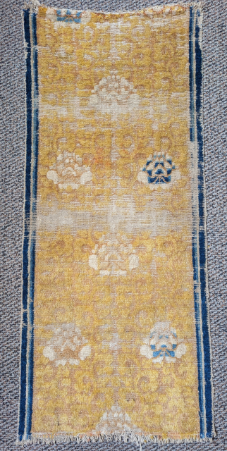 Fragment of a very old Ningxia runner with lotus flowers and faint vinescrol ornament