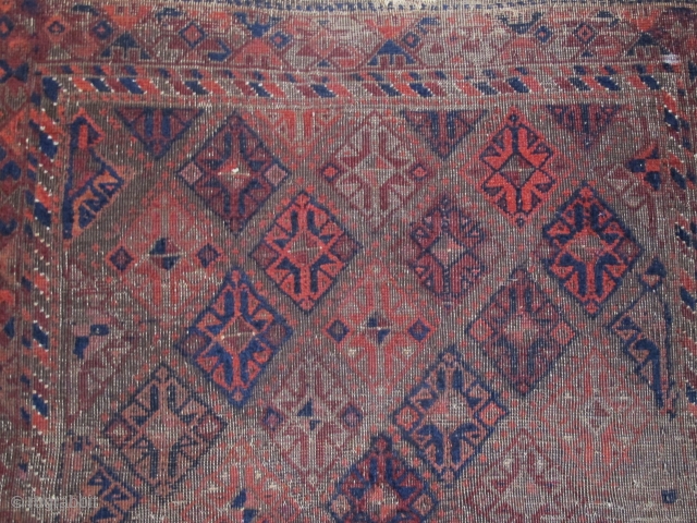 Square-shaped Baluch rug with a repeat diamond latch-hook design. All good color with a subtle but effective use of to tone. Thick patches of indigo dyed pile contrasting with corroded brown and  ...