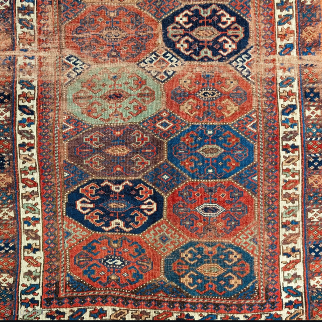 Northwest Persian Kurdish rug with an unusual octagon and diamond field design.Very nice color including two greens and aubergine. Worn but still beautiful and mostly readable. Bottom outer guard border missing. 3'7"x6'2" 