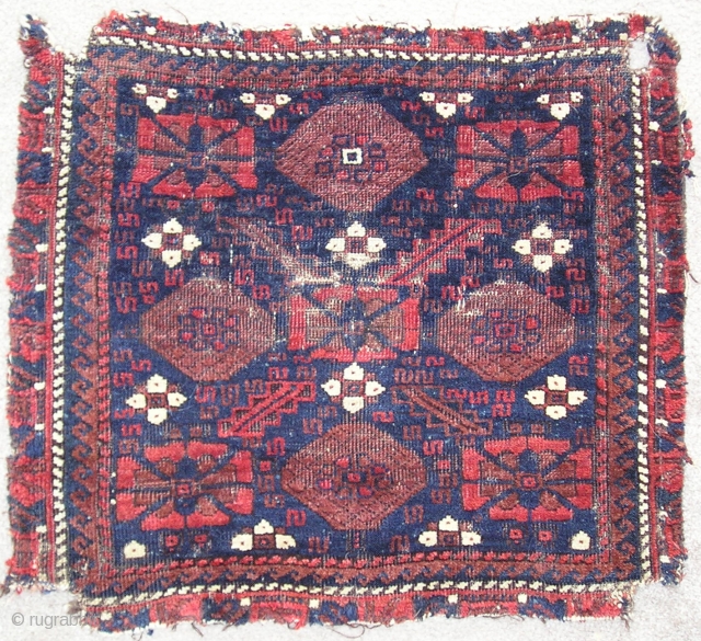 Baluch minakhani bagface ( khorjin fragment ) with saturated color and interesting features for the structurally inclined including alternating bands of Turkish and Persian knots and a pronounced pattern of weft shifts  ...