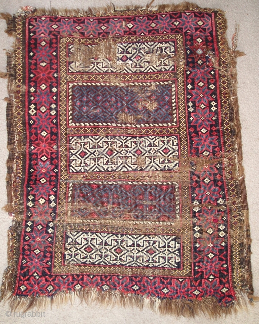 Enigmatic Baluch weaving. Probably a Poshti but perhaps some other sort of bag or bridge. It is symmetrically knotted  using a design repertoire  more commonly seen in flat-woven pieces. The  ...