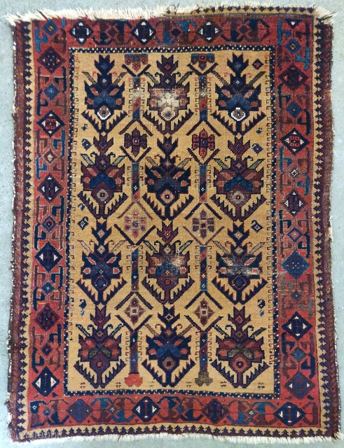 Small camel ground Baluch rug with stylized pallettes. Very fancy with highlights in white cotton pile, yellow wool pile (not camel), and peach. 2'6x3'2" Worn but very readable and enjoyable with great  ...