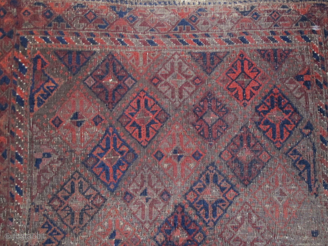 Square-shaped Baluch rug with a repeat diamond latch-hook design. All good color with a subtle but effective use of to tone. Thick patches of indigo dyed pile contrasting with corroded brown and ...