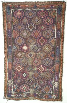 small symmetrically knotted Baluch rug with fantastic color (including three greens, several blues, pink, orange, purple and chocolate brown) and a simple border with geometricized flowering plants. 84x132 cm(33\'\'x52\'\' inches)   