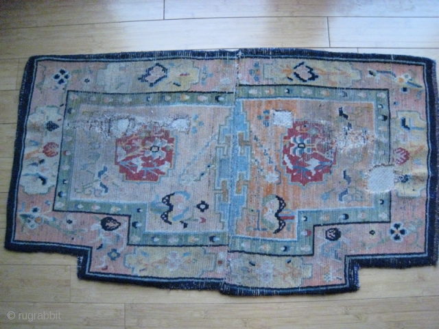 Old Tibet saddle cover, wool on cotton.  26 x 45 inches.  Holes for straps evident.  Somewhat faded.  Edges bound in dark blue wool, cotton upholstery backing.   