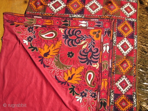 Suzani silk thread embroidery on red cotton bedding cover.  30 inch side triangle, with 6 inch golden fringe.  Excellent condition.  Uzbek/Afghan origin.        