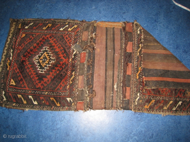 Baluch saddle bag.  Pile fronts, flat weave back.  Somewhat worn.  Purchased in Peshawar, Pakistan in 1980.  25 by 52 inches.  SOLD       