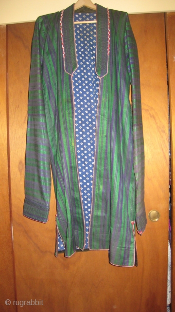 Afghan man's coat choghah.  Classic blue and green stripe silk outside, cotton print inside.  Corduroy lining edge, red and white cotton braid decoration.  Sleeve ends embroidered with blue/black stitching.  ...