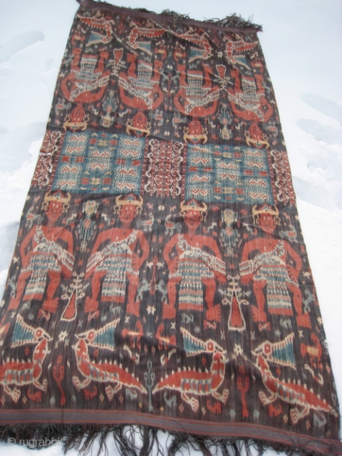 SOLD.  Large eastern Indonesia Ikat, 49 inches by 100 inches.  Motifs of men wearing horned hats, alligators and birds.  Natural colors bright throughout.  Fringes intact, no holes.   ...