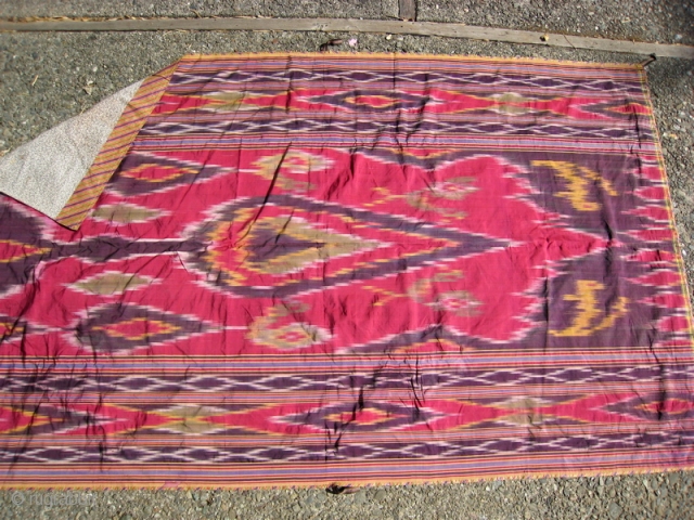 Uzbek silk Ikat, large motif with border.  Striped edge binding, small patterned cotton backing.  No repairs, but silk is very fragile in the center. 
      