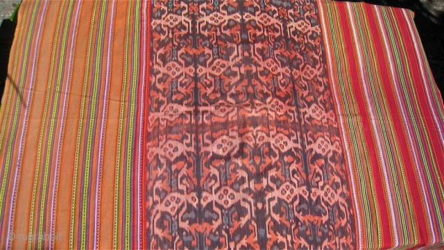 Ikat center, striped edge cloth from Timor, Indonesia.  48 inches by 68 inches.  Purchased in west Timor in 1976.   Bright colors, no holes or repairs.    