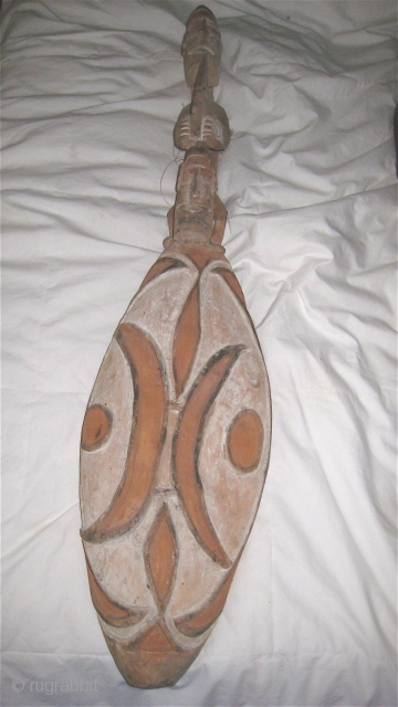 Asmat (Indonesia, West Papua) sago dish in shape of a shield.  Double human forms on the handle.  34 inches long, 8 inches wide.        