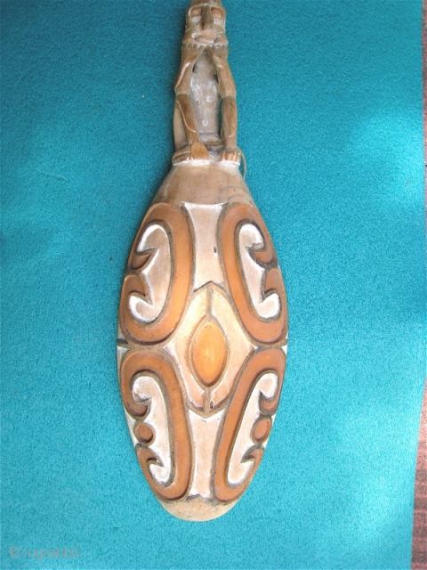 Sago dish in shape of shield from Irian Jaya, Indonesia (West Papua/ New Guinea ).  10 x 30 inches.  Deeply incised design emphasized with ochre and white dyes.   