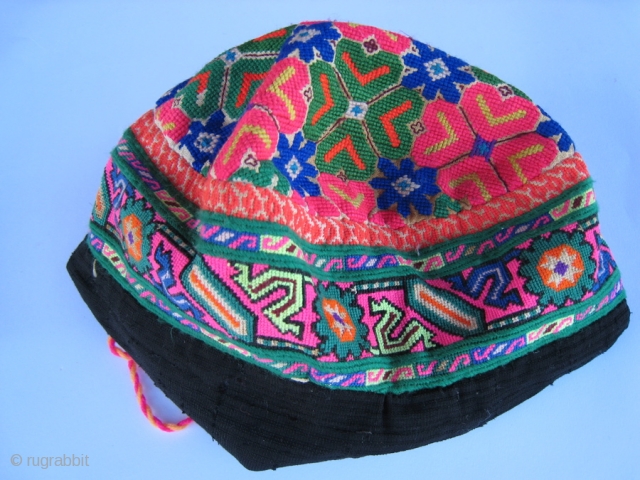 Woman's hat from Hunza, Pakistan.  Very fine cross stitch silk embroidery on cotton.  Crown lined with flowered cotton.  Extra black fabric sewed on so it could be used as  ...