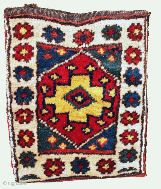 Here's an example of how one funky dye doesn't get in the way of a cool weaving.  The "ivory" border of this Kurdish chanteh is a very light rose-red on the  ...