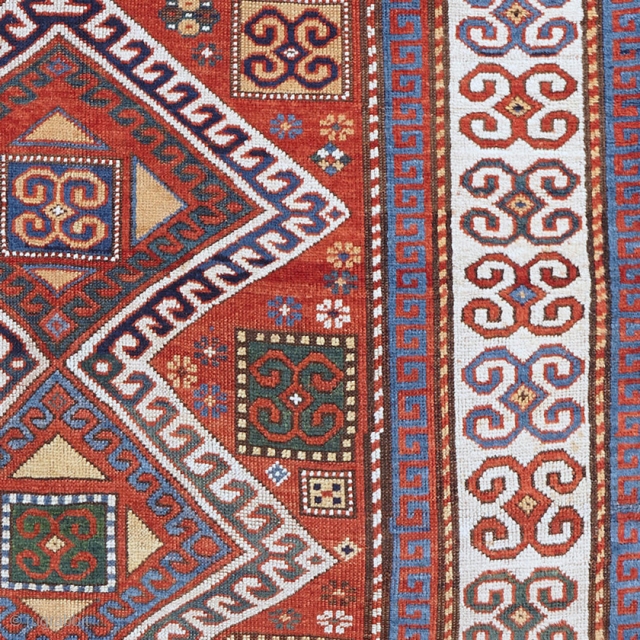 Karachopf Kazak, late 19th century. 74" x 51". a cheerful Kazak featuring a well-drawn ram's horn ivory border framing a red ground with an ivory outlined triple medallion. The ram's horn motif  ...