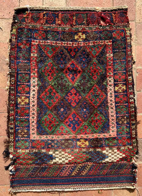 Jaf Kurd bagface. Originally the piled face of one half of a double saddlebag (khorjin). Across the bottom is a piled panel (with chevron design) where the bottom fold of ...