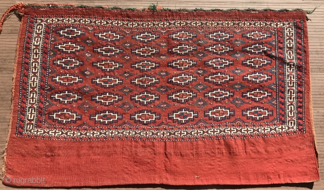 Yomut chuval, complete with red plainweave back. Flatweave with Memling-gul design in sumac and other weft-wrapping.  49” wide by 30” deep (125 cm x 76 cm).  Overall condition very good.  ...