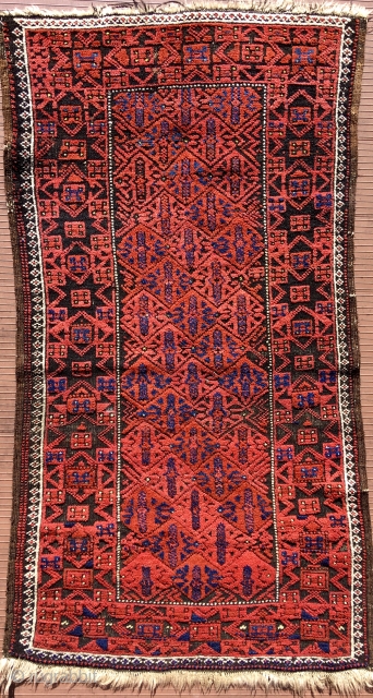 Baluch rug.  53” x 28” (135 cm x 72 cm)(Width varies). Very attractive little rug in good condition.  The surface appears embossed because the black is corrosive and worn shorter,  ...