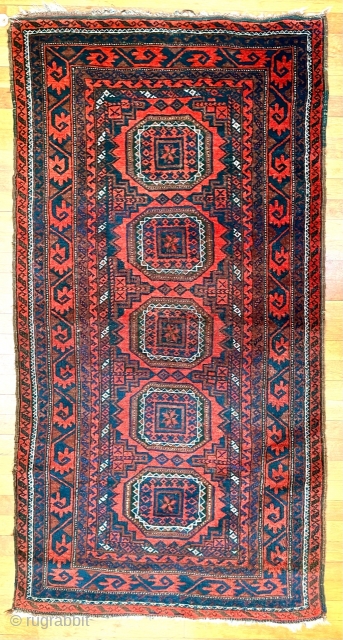  A attractive Baluch rug in excellent condition.   Size is typical for Baluch--67 inches x 35 inches (170 cm x 89 cm).  Turkmen design motifs—field with five Salor-like guls,  ...