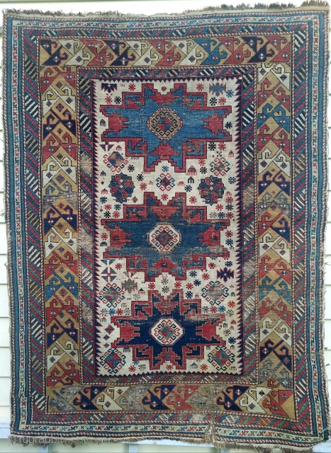 Ivory field Leshgi star rug- about 4.7 x 3.8.  Beautiful color including yellow ground border.  Pretty much intact. Has wear, oxidation, glue residue on back, and small slit lower end  ...