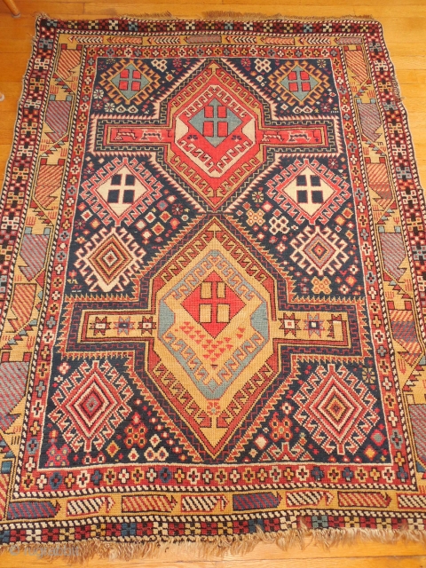 SHIRVAN WITH A DESIGN BURSTING WITH FOLK ART ELEMENTS.

SIZE OF 45 X 58 INCHES.

CHEMICAL RED DYE IN THE CENTER MEDALLION.

JUST WASHED.EXCELLENT PILE.

ONE OLD REPAIR ON THE EDGE AS SHOWN.    