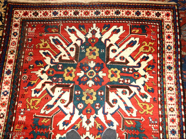 EAGLE KAZAK IN VERY GOOD PILEAND CONDITION 58 X 86 INCHES
NOTE THE NUMEROUS ANIMALS WANDERING IN THE FIELD               