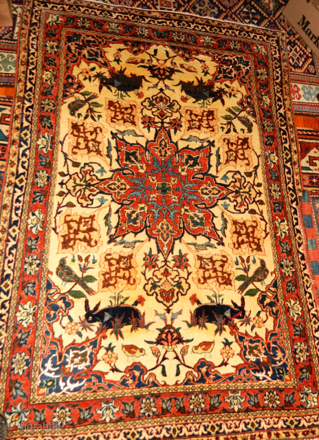 AN exceptionally lovely old persian carpet with rabbits and birds                       