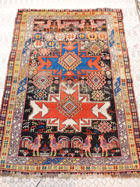 VIBRANT FOLK ART FILLED SHIRVAN WITH JUST A BIT OF WEAR . ABOUT 4 X 5 FEET 

LOOK ON MY BOYLSTON ASSOCIATES ANTIQUE CAUCASIAN RUGS FOR THE PRICE     