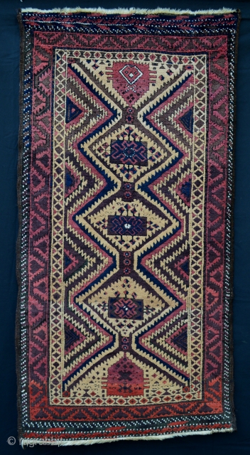 Mushwanni Baluch in excellent overall condition with soft, silky wool, a beautiful old aubergine and incorporating natural camel-hair in the field - 1.65m x 0.87m (5' 5" x 2' 10").   