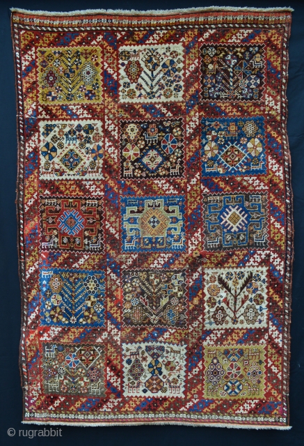 Rare, compartmentalised, small knotted-pile mid 19th century Qashqa'i rug in poor condition with various old reweaves but incredibly beautiful and collectable. Age is difficult to determine but this rug has a very  ...