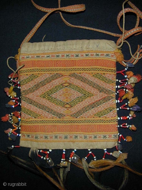 Timorese Betel-nut Bag (Aluk). Early 20th Century. Antoni people. Cotton flatweave and supplementary weft wrapping with glass beads, bamboo, and horsehair. 15 x 14 cms excluding strap and hair.    