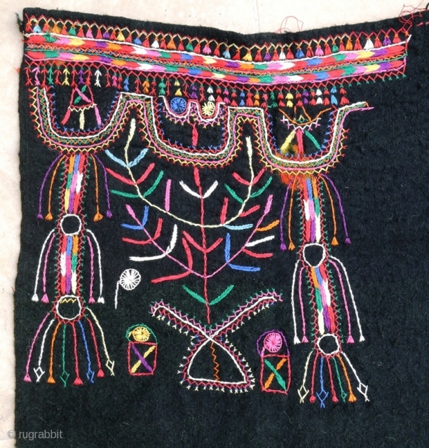Cotton embroidery on "resist dying" felted wool textile. South Tunisian bride's headdress, first half 20th c. 83 x 91 cm (2'9" x 3')ex tassels. V good condition.      