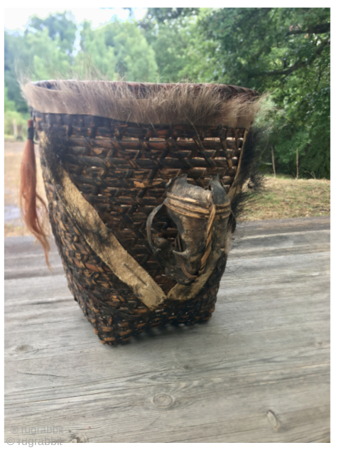 This object is a Naga tribal warrior's basket (also known as a headhunter's basket), typically originating from the Nagaland region of northeastern India or Burma. These baskets are significant cultural artifacts of ...