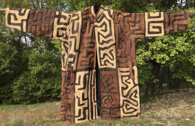 Bakuba raffia coat/jacket. 
Congo, probably early or mid 20th century. 
Unique, unisex coat for special people, exhibitions, tribal fashion venues. Terribly chic or kitsch, as you like. 
The coat wearing lady in  ...