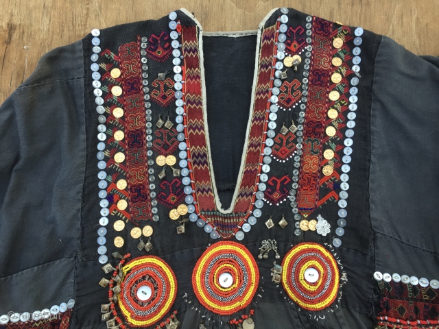 Nuristan. Jumlo or woman wedding dress from Kohistan/Nuristan, Northern Pakistan and Afghanistan. Heavily silk embroidered on black cotton, with lots of white and copper plastic buttons, metal roundels, lead beads, etc. Early  ...