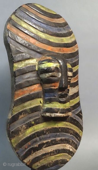 Africa, Congo, Songye tribal group war and dance ceremonial wooden shield. Cm 25x50 ca. Mid 20th. c. With front mask. Polychromatic. In good cond.         