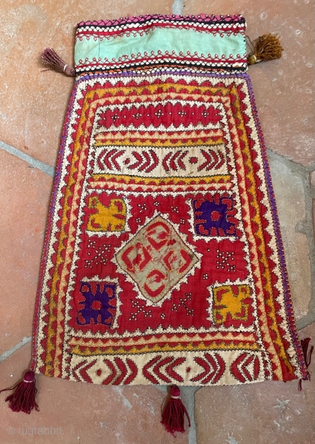 Tobacco bag from Sindh. Applique, patchwork and embroidery on a cotton ground. Mid 20th century. Shows signs of wear (see photos), but is cheerful and attractive.       