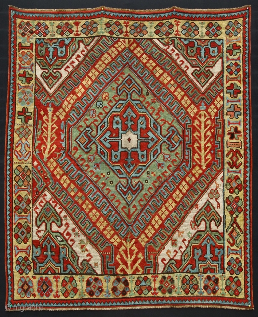 Master Village Oushak from 1850 perhaps earlier with yellow field border.
Unusual composition with tribal figures.

Size: 235x183 cm (7.8 x 6 ft.)
More pictures available (All pictures are taken in the sun light)  