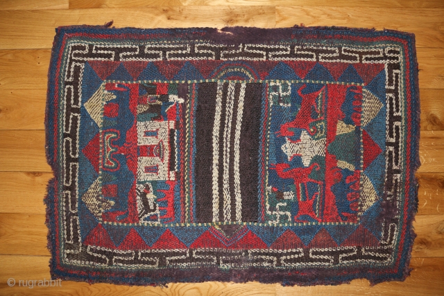 This charming piece is a tableau of Nomadic life. One side of the saddle cloth depicts a small monastery building, with a rider on horseback on the left and a Tibetan mastiff  ...