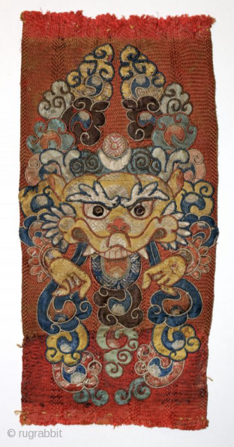 A delightful and very fine Tibetan silk appliqué of Kirrtimukha, or Zpatr. The piece is small and the appliqué elements are likewise very fine. Some areas are embroidered. (see photos) The background  ...