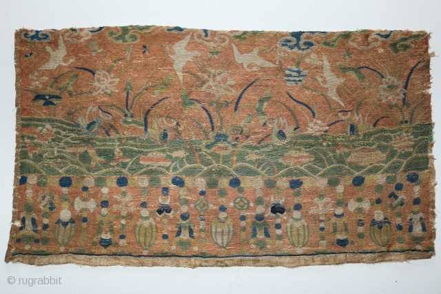 A Ming dynasty sutra cover. Silk embroidered on a gauze ground with design of fish and ducks in a pond with cranes in the sky. The bottom border is hanging jewels and  ...