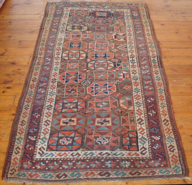Kurdish c1880 217x137 cm (7'1" x 4' 6"). The colours are lovely in this mellow antique Kurdish village rug c1880. It was made in Iran, is in good condition with even wear.  ...