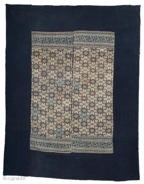 A Tu Jia blanket from Hunan province, China. Cotton foundation with cotton supplementary weft design in two loom-width panels. Original indigo blue border. Central part measures 75cm x 110cm, overall dimension 122cm  ...