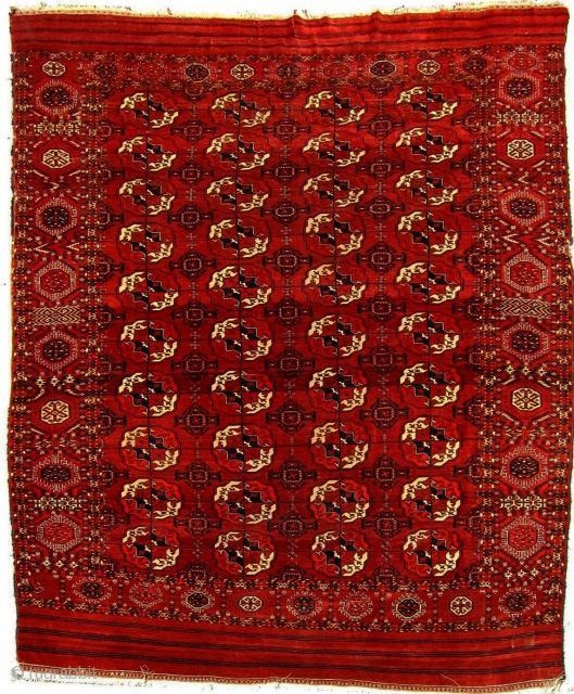 Late 19th/early 20th Century decorative Tekke main carpet, 6'10" x 10'6". Probably a hot red in the details, obvious from the back, but mellow on the front. Unusual in that the skirts  ...